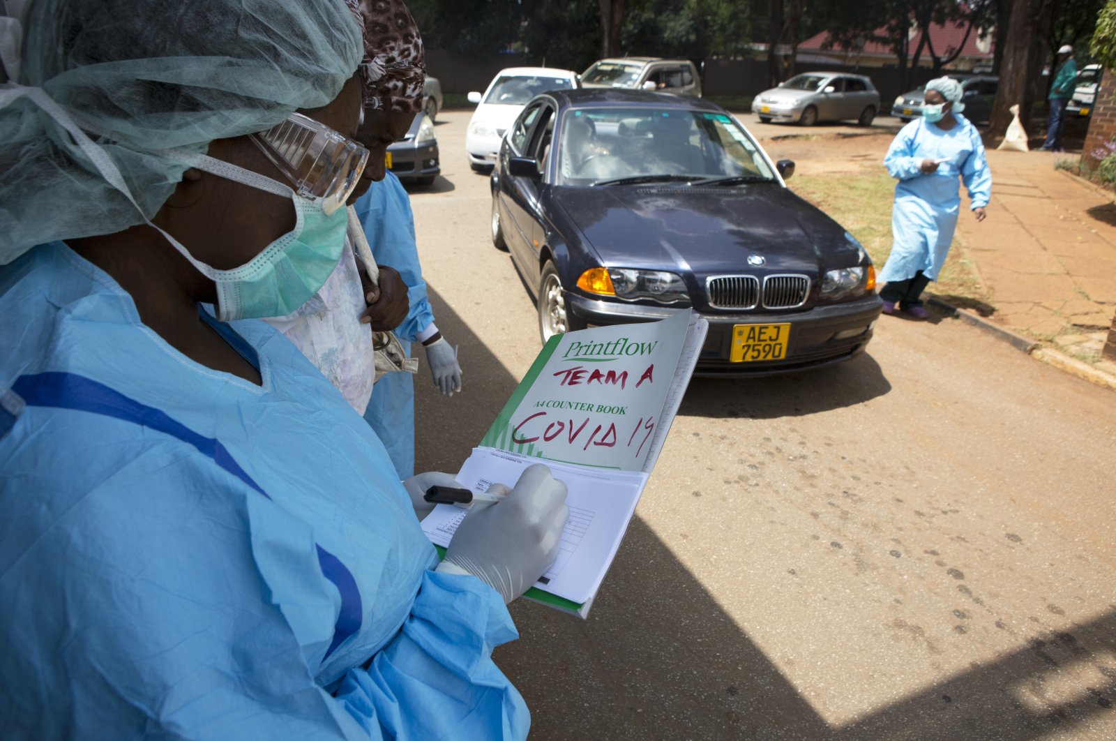 Health workers screen motorists and people visiting a public hospital in Harare, Zimbabwe, Saturday, March 21, 2020, after Zimbabwe announced its first case of coronavirus, in one of Africa's most visited tourist spots. (AP Photo)