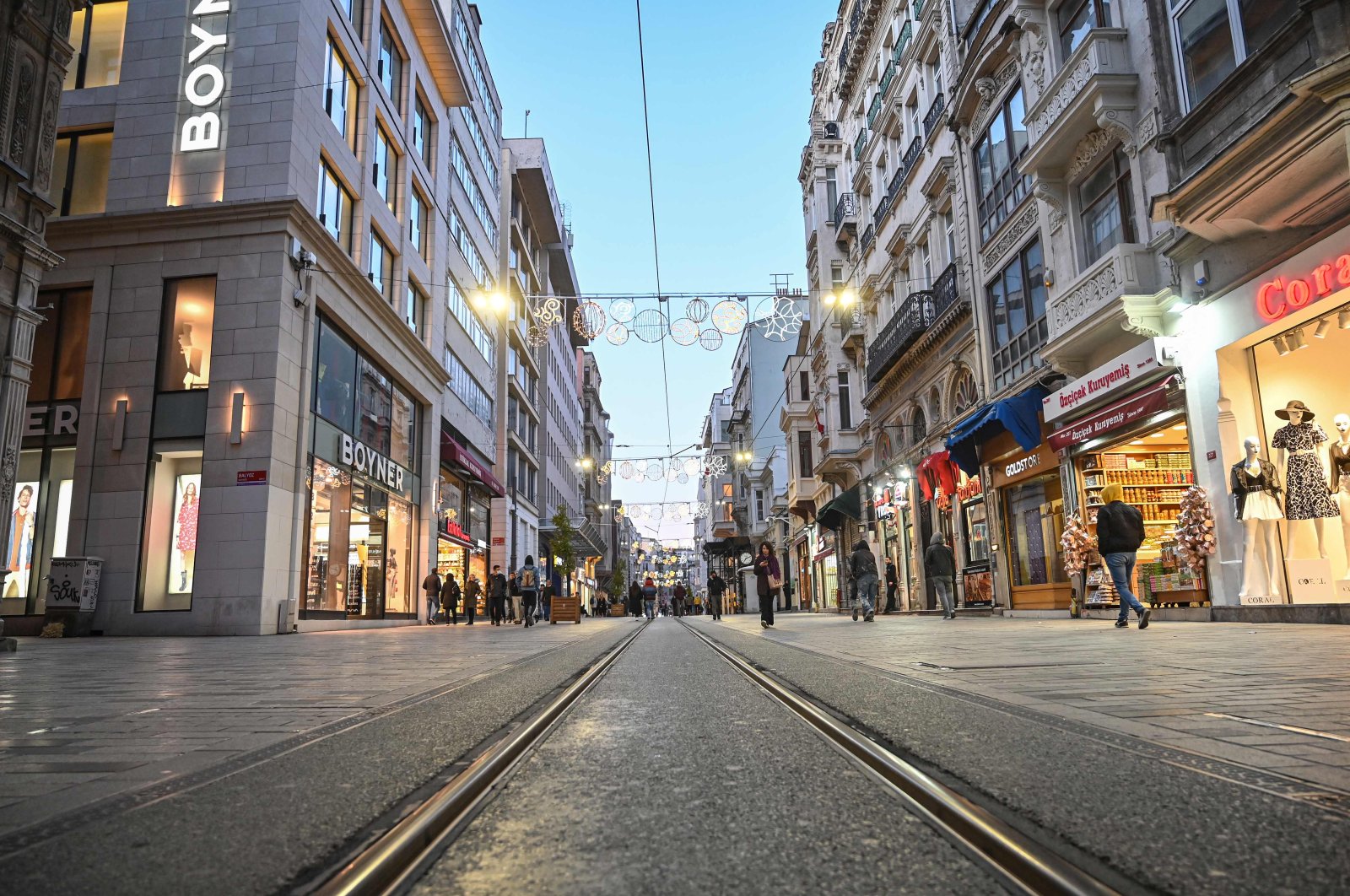 People walk along a nearly empty Istiklal Avenue amid the COVID-19 pandemic, in Istanbul, March 17, 2020. (AFP Photo)