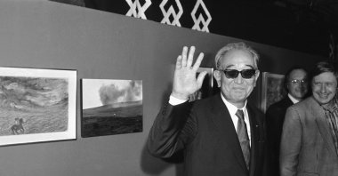 In this Sept. 19, 1985 photo, Japanese movie director Akira Kurosawa salutes the photographers when visiting the exhibition "About Ran" held at Paris Georges Pompidou National Center for Art and Culture. (AP Photo)
