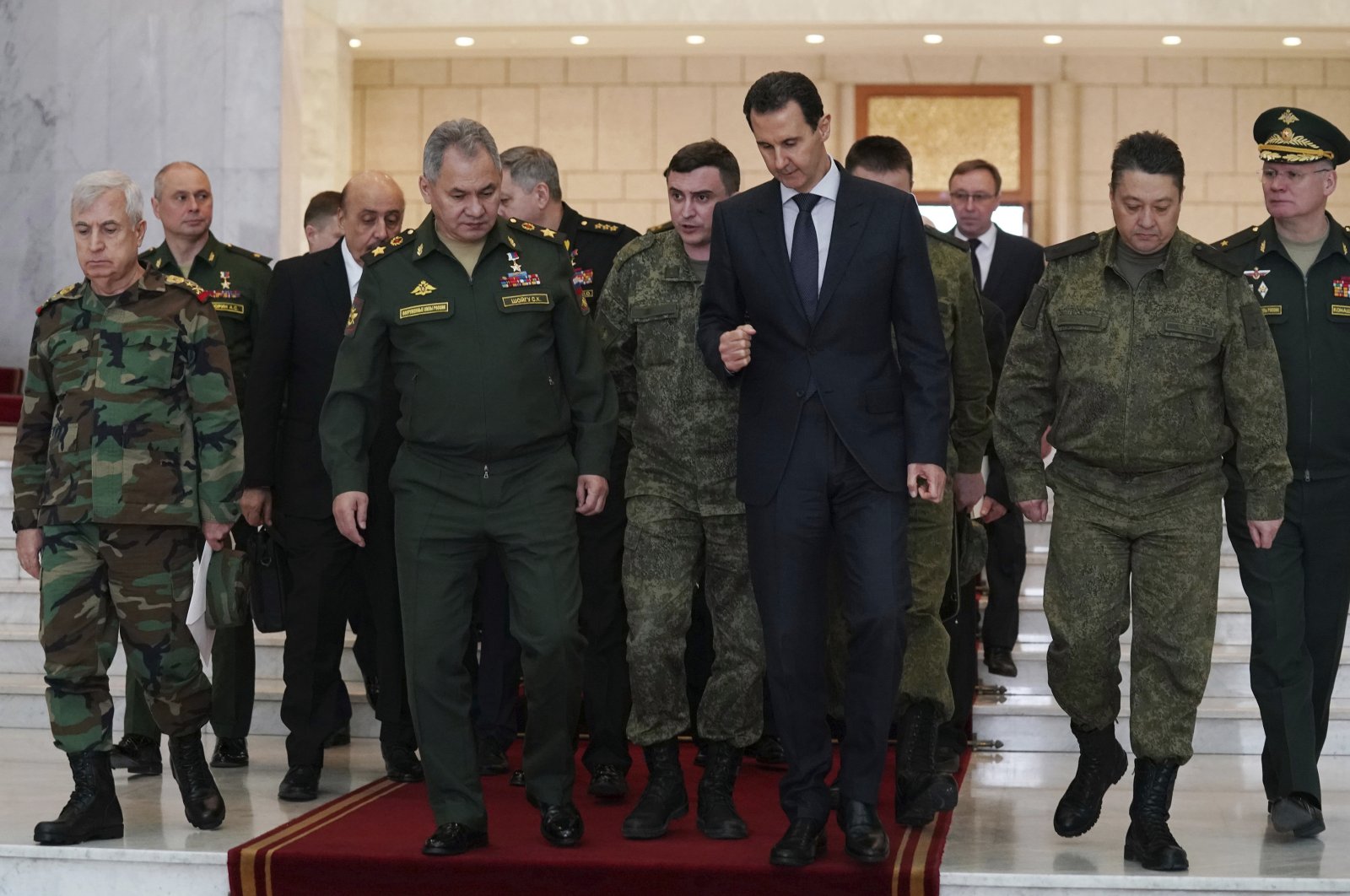 In this photo released by the Syrian official news agency SANA, Bashar Assad, center right, speaks with Russian Defense Minister Sergei Shoigu, center left, before their meeting in Damascus, Syria, Monday, March 23, 2020. (AP Photo)