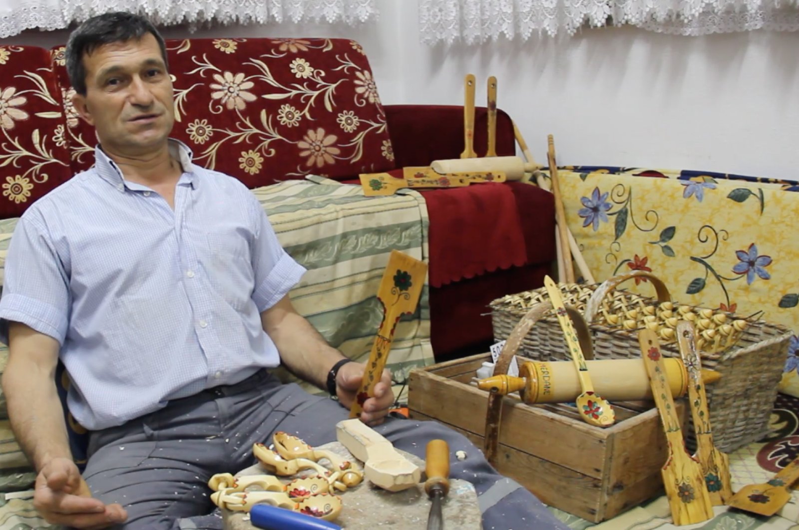 Lütfü Uğur poses with his wooden spoons, tablespoons, ladles and other products. (AA Photo)