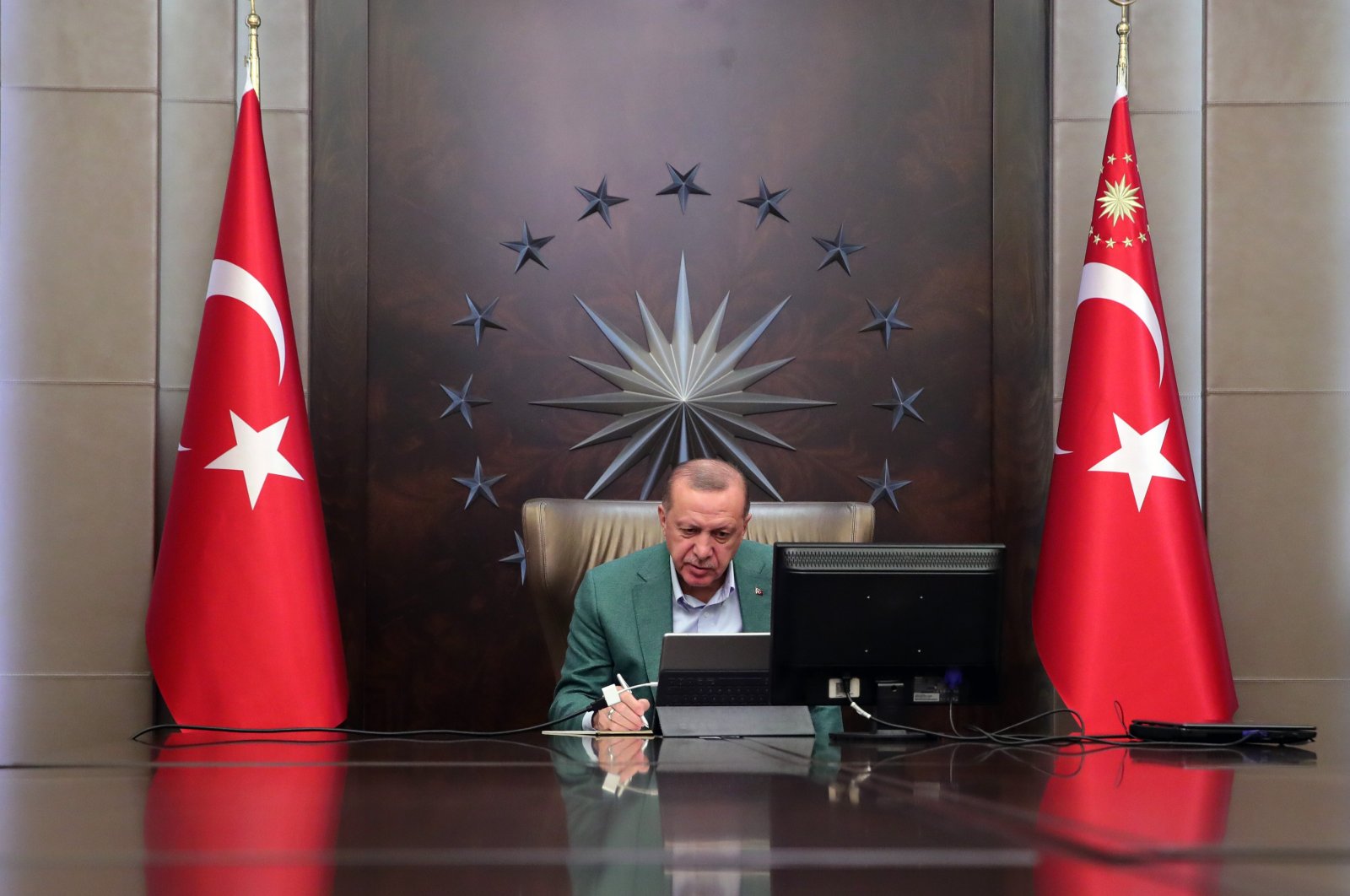 President Recep Tayyip Erdoğan participates in a teleconference with his Cabinet amid the coronavirus outbreak, in Ankara, Turkey, Monday, March 23, 2020. (IHA Photo)