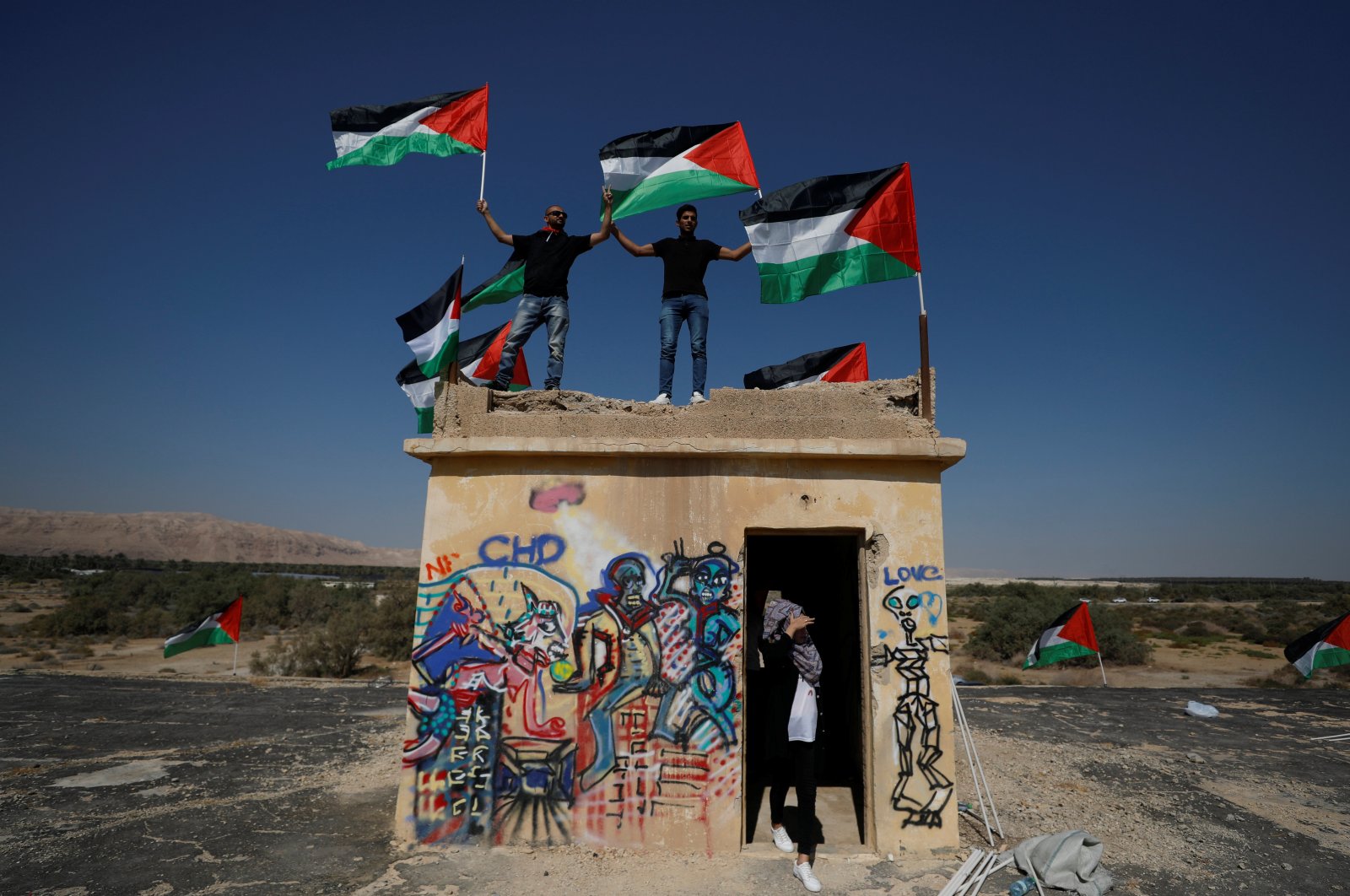 Demonstrators hold Palestinian flags during a protest against illegal settlements near the Dead Sea in the Israeli-occupied West Bank, Sept. 28, 2019. (Reuters Photo)