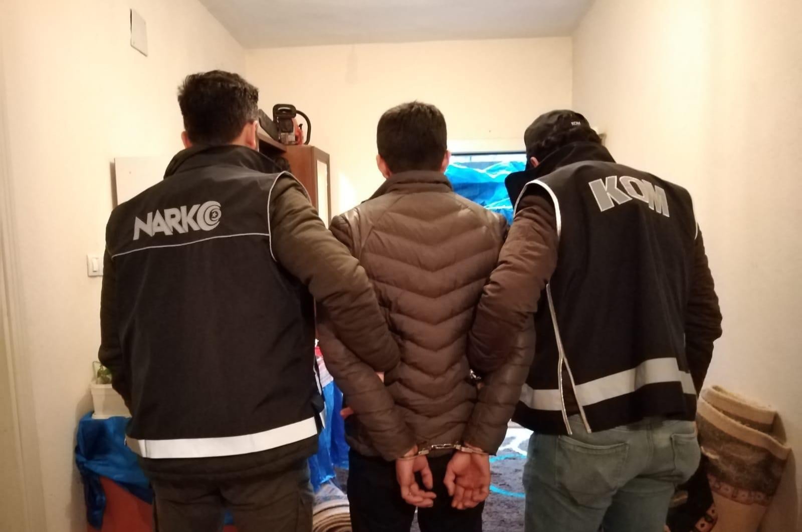 Police officers escort a man captured in counter-narcotics operations, Şırnak, Monday, March 23, 2020. (İHA Photo)