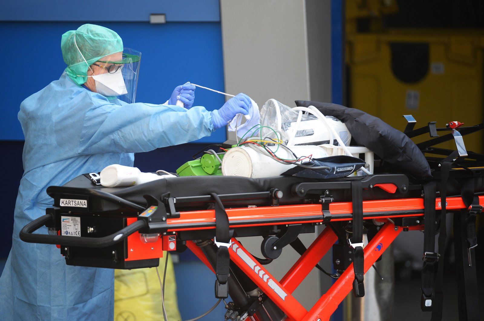 A nurse anesthetist disinfects material of ambulances which carried six coronavirus patients at the Brest hospital, evacuated by air from the French eastern city of Mulhouse, in Brest, western France, on March 24, 2020, on the eight day of a lockdown aimed at curbing the spread of the COVID-19 (novel coronavirus) in France. (AFP Photo)