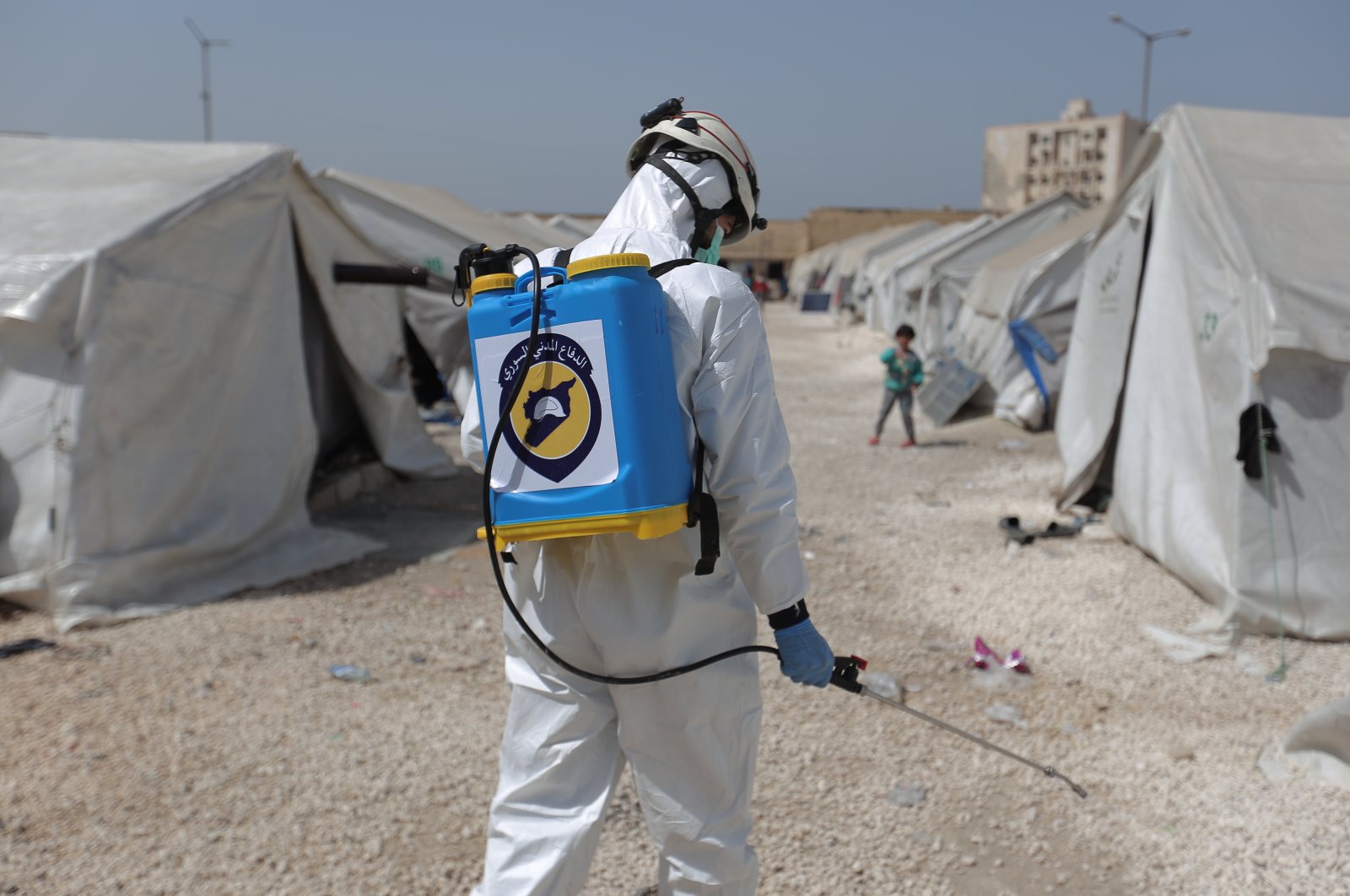 White Helmets civil defense teams try to conduct disinfection works in crowded camps and buildings in Syria's Idlib, March 24, 2020. (AA Photo)