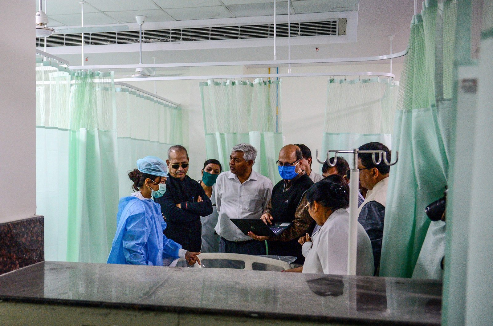 Health department officials and doctors participate in a mock drill practice with a mock patient at SRN Hospital, Allahabad, Wednesday, March 18, 2020. (AFP Photo)