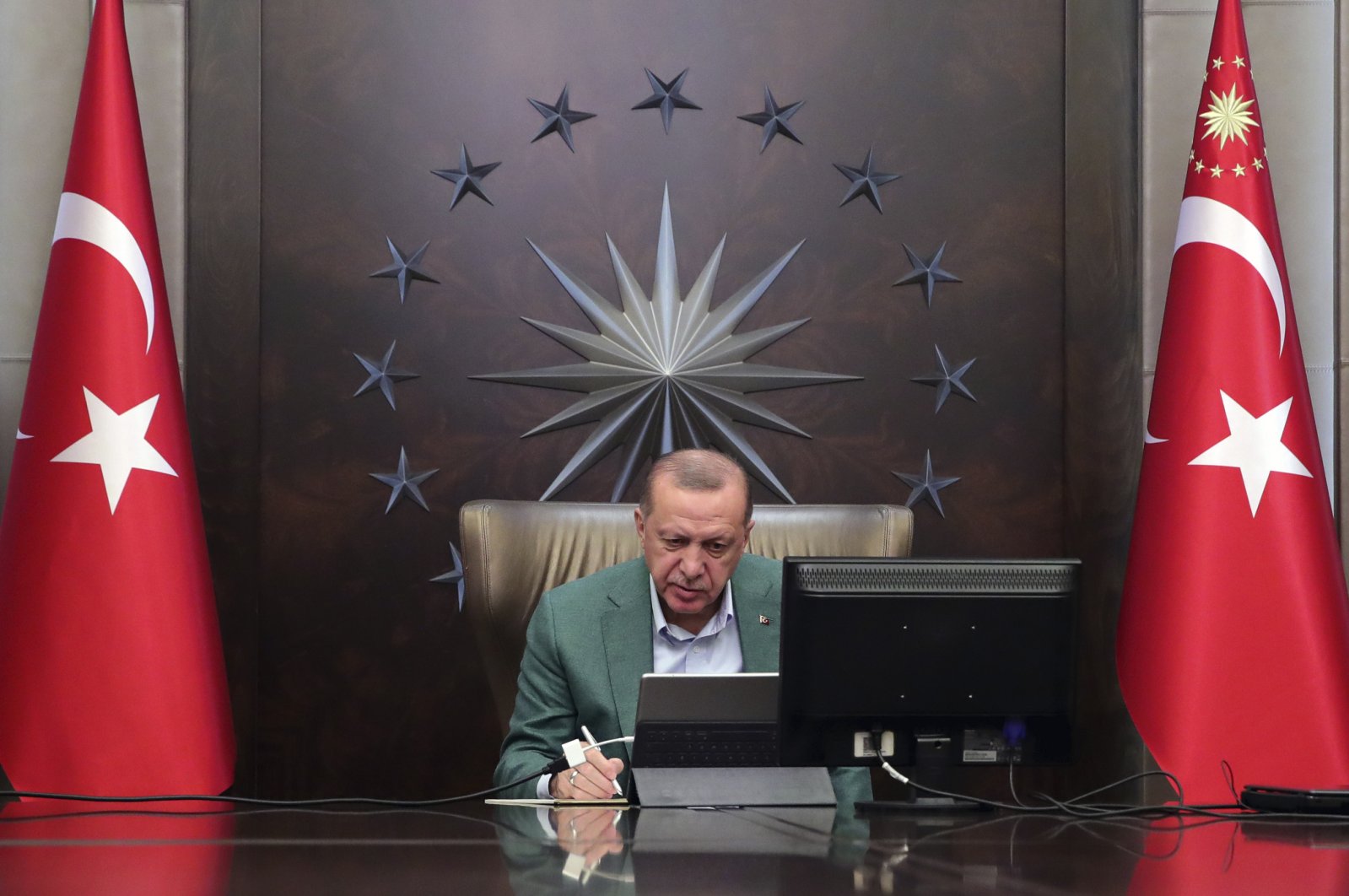 President Recep Tayyip Erdoğan participates in a teleconference with his ministers amid the coronavirus outbreak, in capital Ankara, Monday, March 23, 2020. (AP Photo)