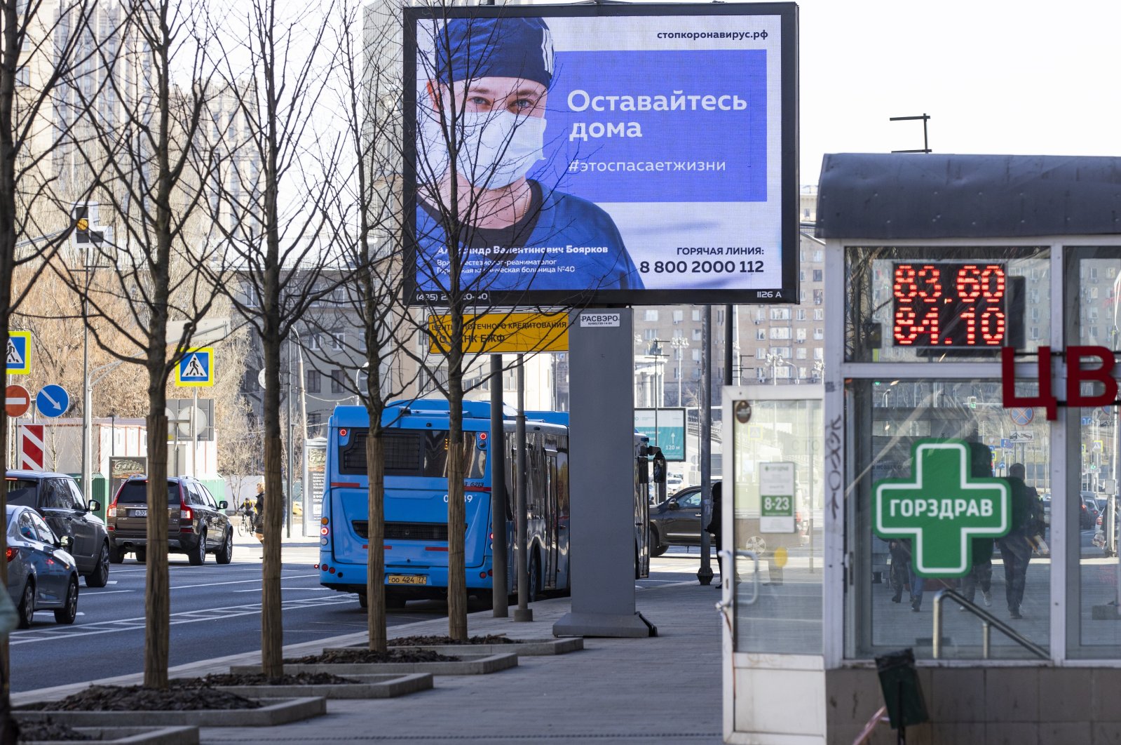 An electronic billboard showing a doctor wearing a medical mask with the words reading "Stay home, it will save a life" in a street in Moscow, Russia, Wednesday, March 25, 2020. (AP Photo)