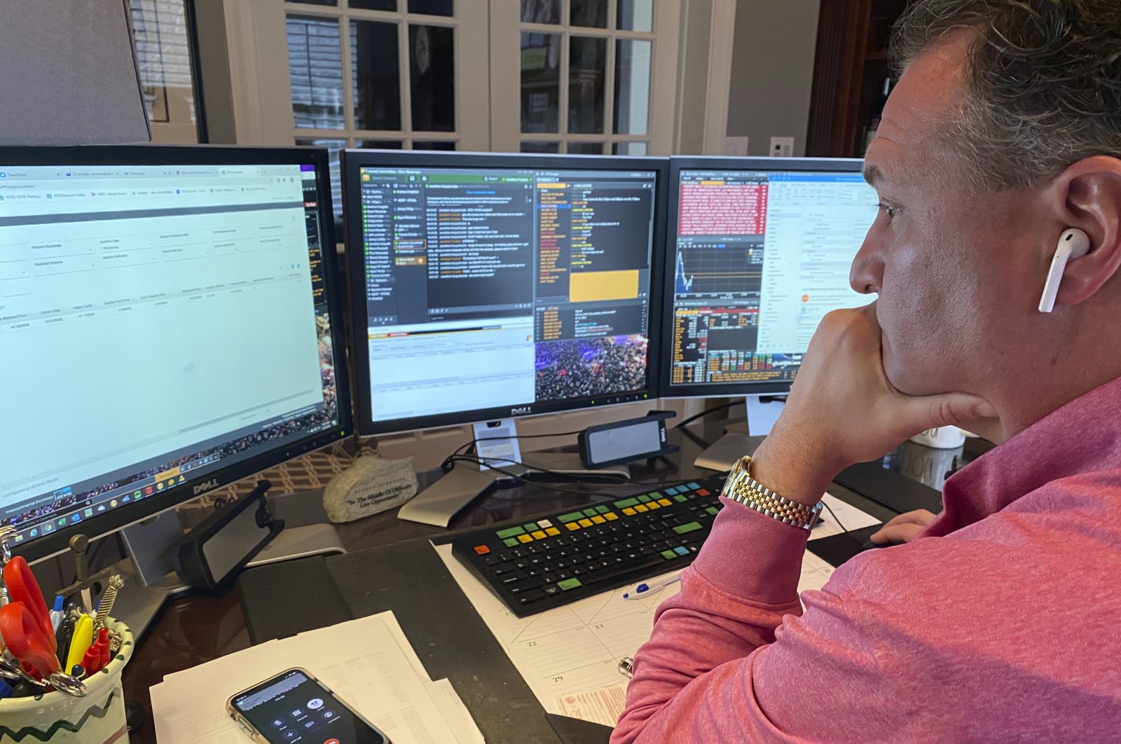 In this image provided by Jonathan Corpina, Jonathan Corpina, Senior Managing Partner at Meridian Equity Partners Inc., who normally works on the New York Stock Exchange trading floor, works in his home office in Armonk, NY., Wednesday, March 25, 2020. (AP Photo)