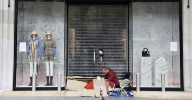 A homeless man asks for alms at Passeig de Gracia, during the COVID-19 outbreak, in Barcelona, Spain, Tuesday, March 24, 2020. (REUTERS Photo)