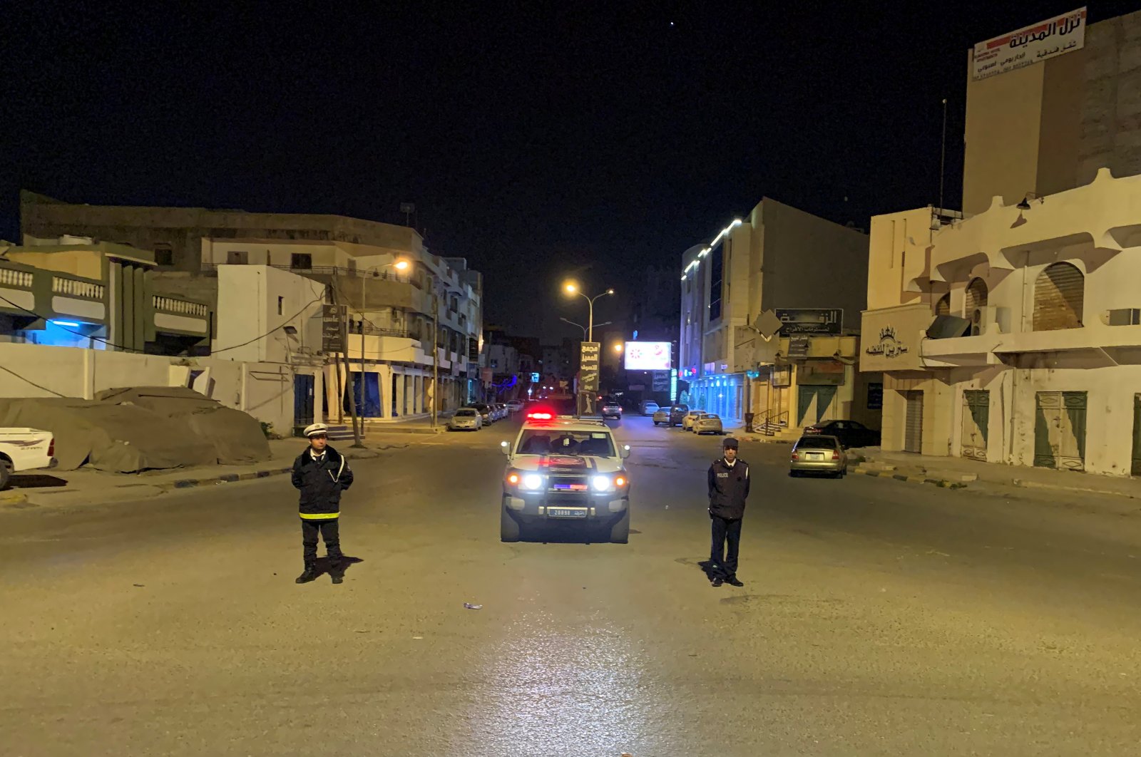 Police officers stand in the middle of the road during a curfew, imposed as part of precautionary measures against coronavirus disease (COVID-19), in Misrata, Libya. March 22, 2020. (REUTERS Photo)