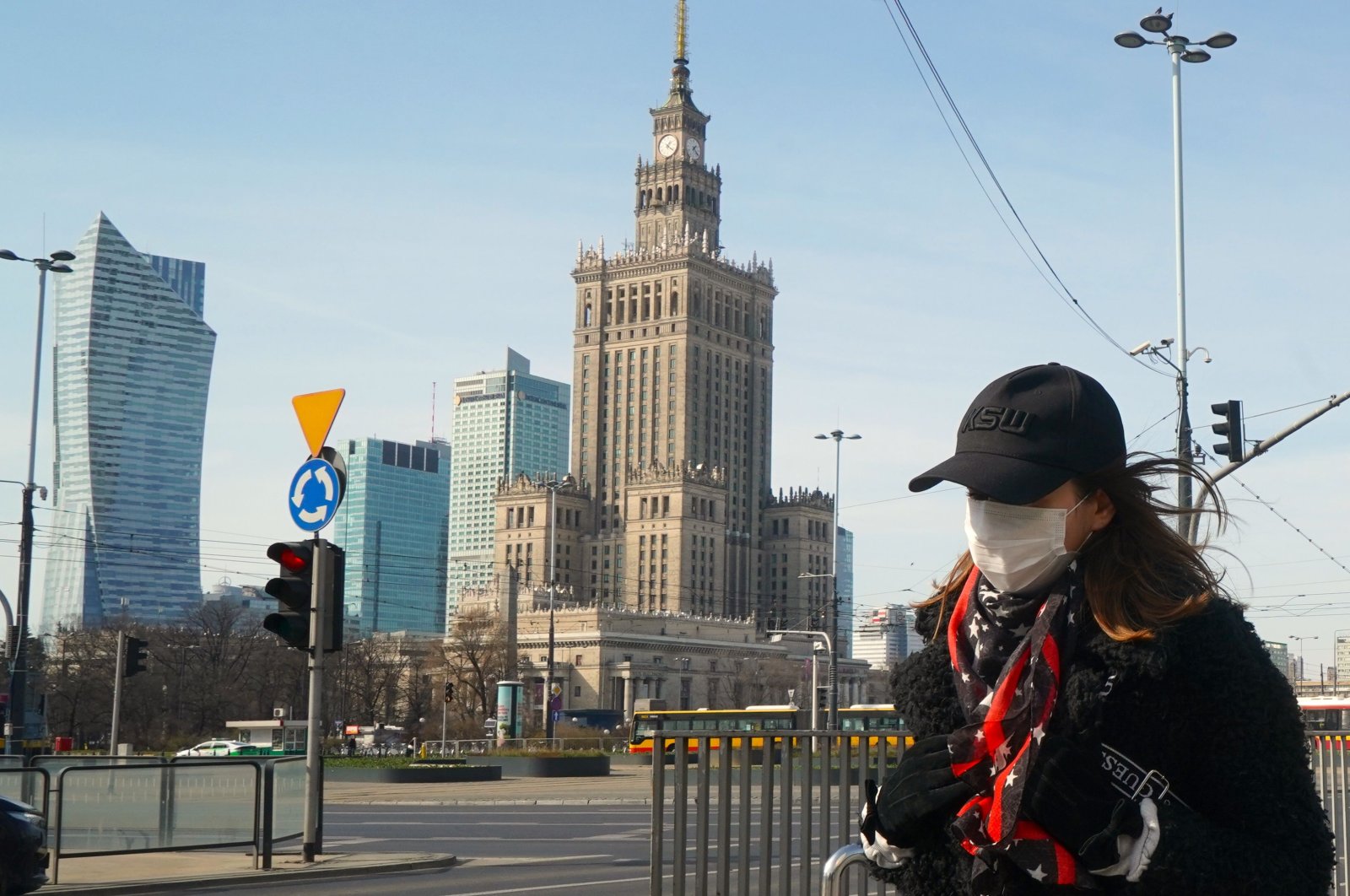 A woman with a face mask walk on March 26, 2020 on a street of Warsaw, amid the novel coronavirus pandemic. (AFP Photo)