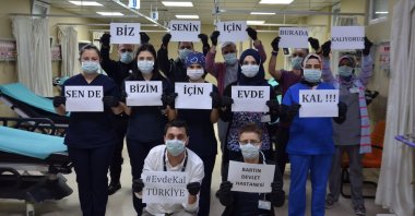 Hospital staff in Bartın, Turkey, hold signs that read “We stay here for you, you stay home for us,” Friday, March 20, 2020. (AA Photo)