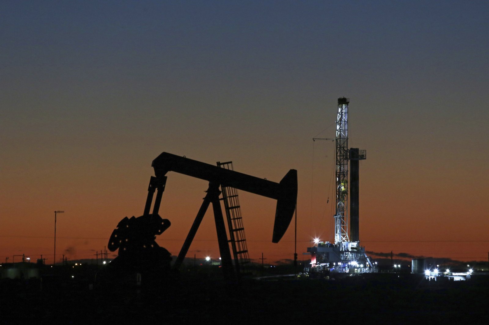 This file photo shows an oil rig and pump jack in Midland, Texas, Oct. 9, 2018. (AP Photo)