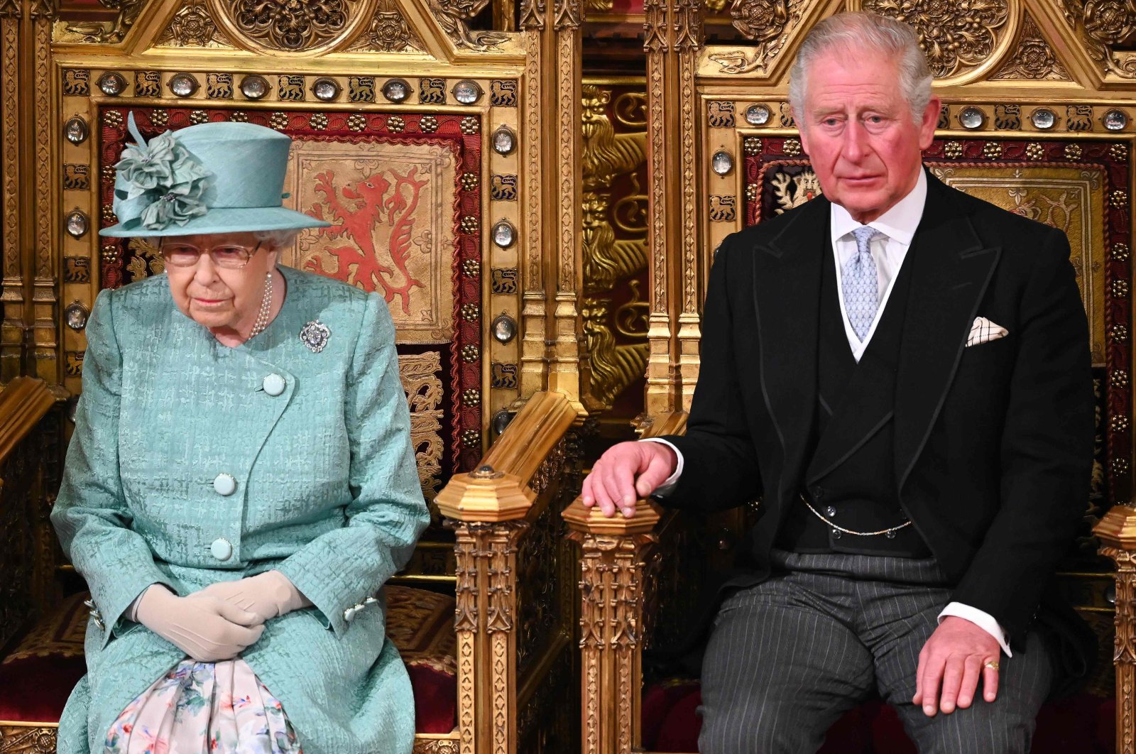 Britain's Prince Charles sits with Queen Elizabeth II on the Sovereign's Throne before she delivered the Queen's Speech in the House of Lords chamber, during the state opening of Parliament in the Houses of Parliament, London, Dec. 19, 2019. (AFP Photo)