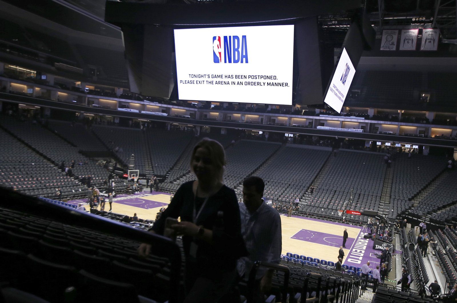 Fans leave the Golden 1 Center after the NBA basketball game between the New Orleans Pelicans and Sacramento Kings was postponed at the last minute in Sacramento, Calif., Wednesday, March 11, 2020. The league said the decision was made out of an "abundance of caution," because official Courtney Kirkland, who was scheduled to work the game, had worked the Utah Jazz game earlier in the week. A player for the Jazz tested positive for the coronavirus. (AP Photo)