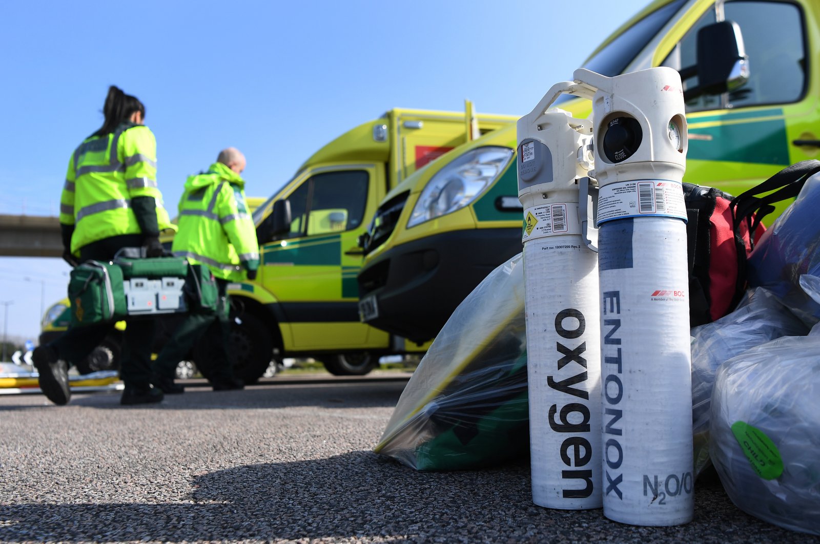 Ambulance workers unload oxygen tanks outside the ExCel Center in London, Saturday, March 28, 2020. (EPA Photo)