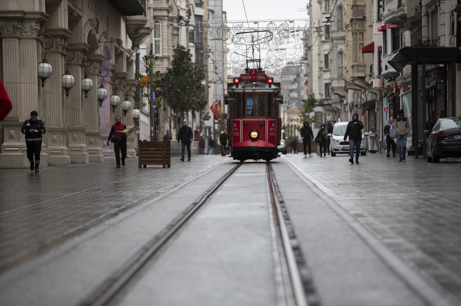 A few people can be seen walking on the usually bustling Istiklal Street which looks eerily empty over coronavirus concerns in Istanbul, Turkey, Tuesday, 24 March 2020. (EPA-EFE Photo)