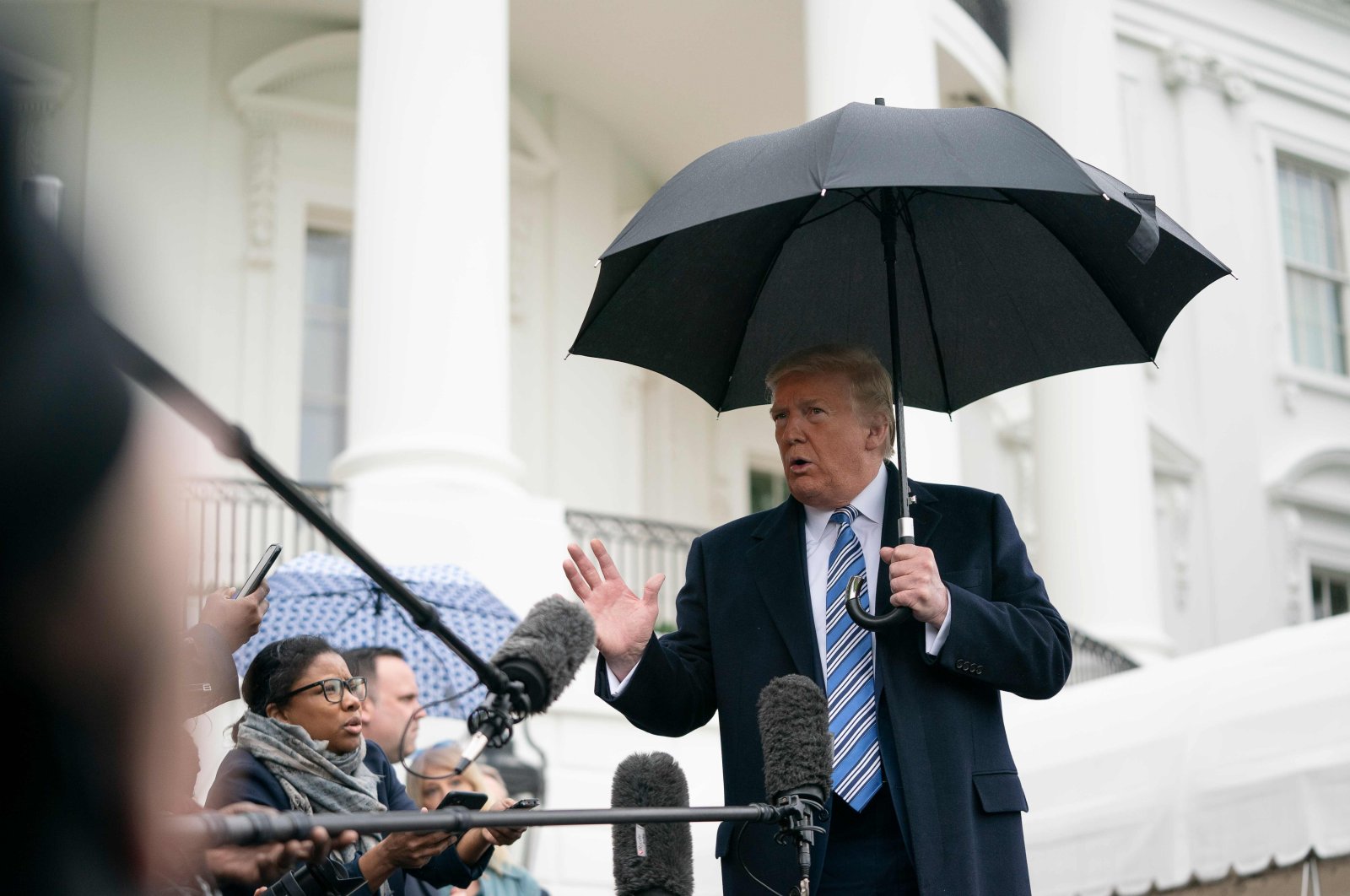 U.S. President Donald Trump speaks to the press as he departs the White House in Washington, DC, on Saturday, March 28, 2020. (AFP Photo)