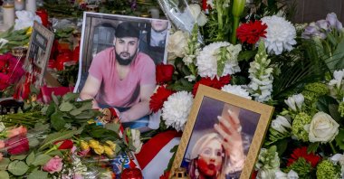 Flowers and pictures of victims are laid near a kiosk in Hanau three days after several people were killed in s shooting there, Feb. 22, 2020,  (AP)