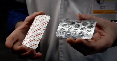 In this file photo taken on February 26, 2020, a medical staff shows at the IHU Mediterranee Infection Institute in Marseille, packets of a Nivaquine, tablets containing chloroquine and Plaqueril, tablets containing hydroxychloroquine, drugs that have shown signs of effectiveness against coronavirus. (AFP Photo)