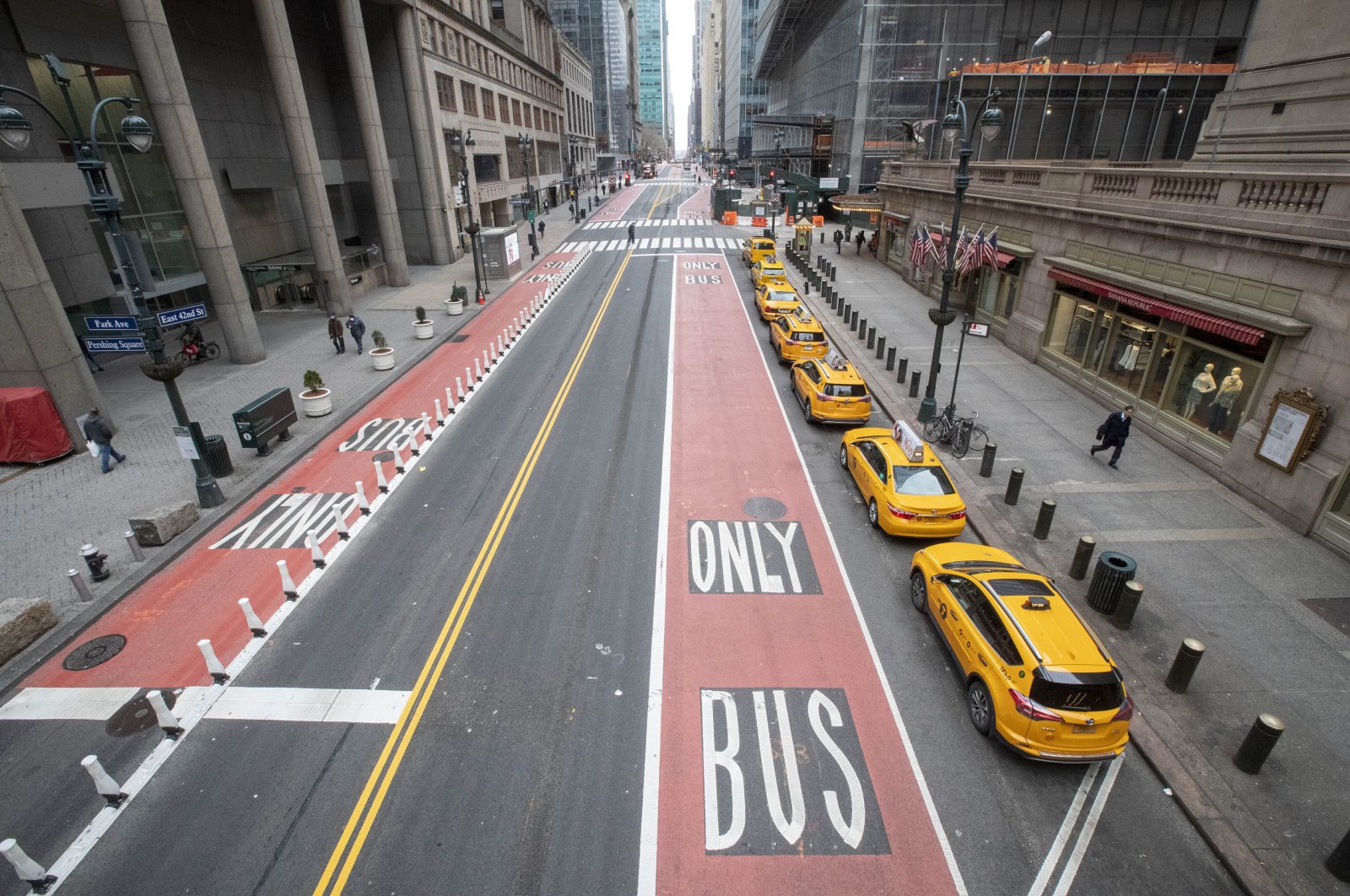 Yellow cabs line up on an empty 42nd Street waiting for fares outside Grand Central Terminal in New York, Wednesday, March 25, 2020. For the millions of Americans living under some form of lockdown to curb the spread of the new coronavirus, not knowing when the restrictions will end is a major source of anxiety. (AP Photo)