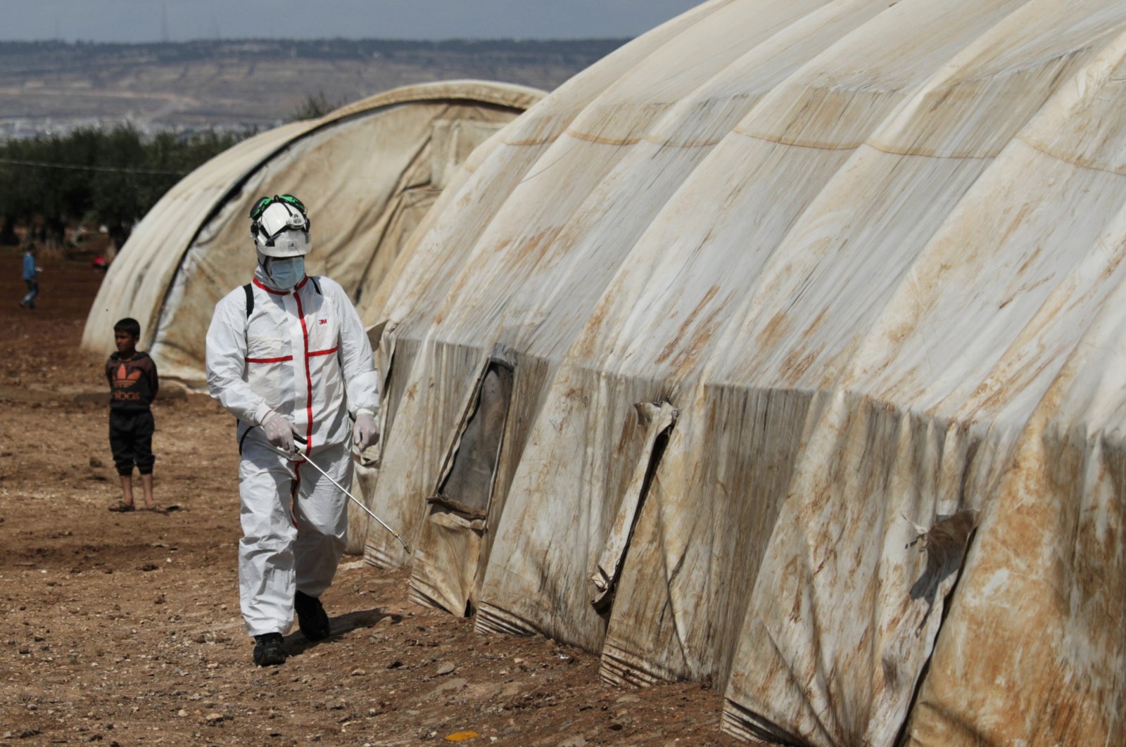 A member of the Syrian Civil Defense sanitizes a tent at the Bab Al-Nour internally displaced persons camp, Azaz, March 26, 2020. (REUTERS Photo)