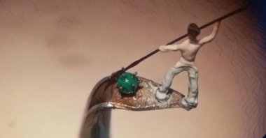 A doctor lances his spear to the figure that represents coronavirus in the artwork of Necati Korkmaz, who is one of three microminiature artists in the world. (DHA Photo)