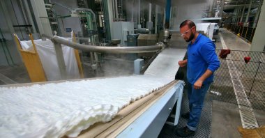 An employee monitors machines at a Turkish polyester producing company in southern Adana, Turkey, Monday, March 30, 2020. (AA Photo)