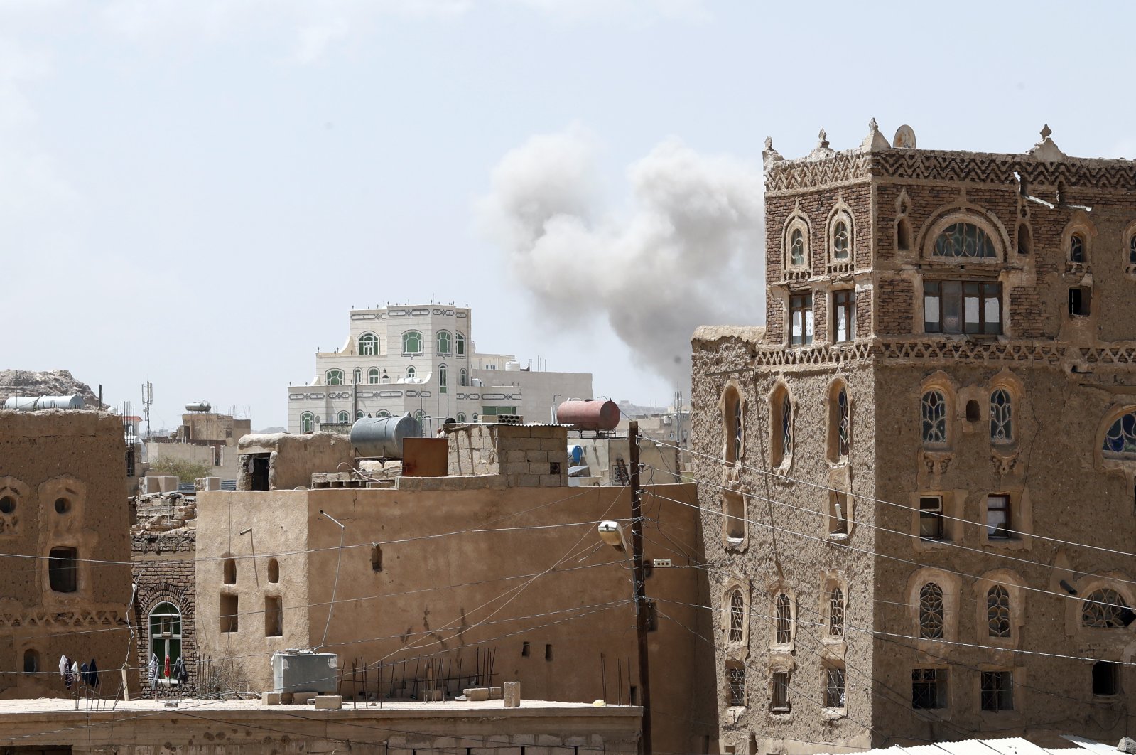 Smoke billows above a neighborhood following Saudi-led airstrikes targeting a Houthi-held position, a day after the Houthis fired ballistic missiles at the Saudi capital Riyadh, Sanaa, Yemen, March 30, 2020. (EPA Photo)