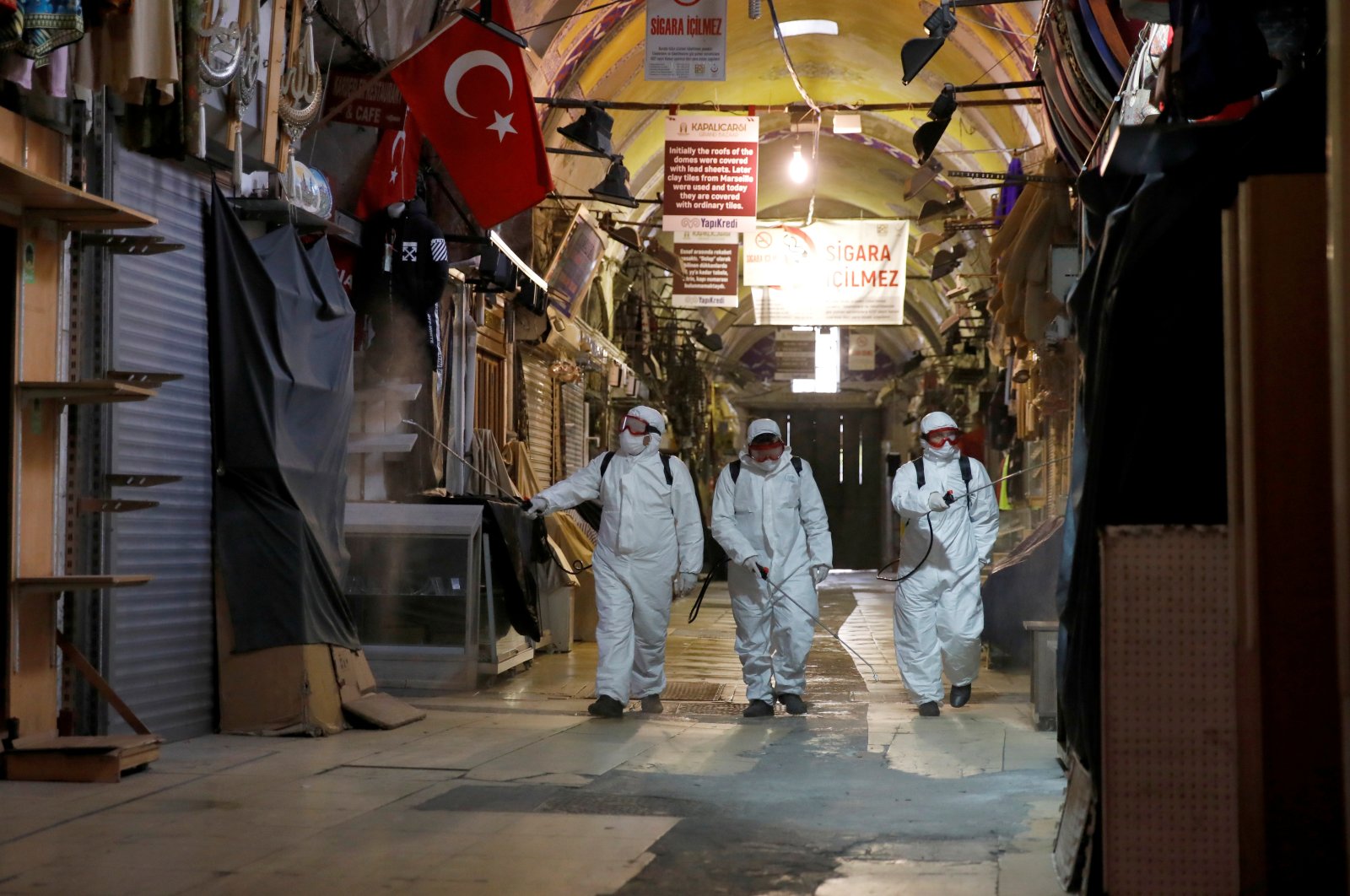 Workers in protective suits spray disinfectant at the Grand Bazaar to prevent the spread of the coronavirus disease (COVID-19), Istanbul, Turkey, Wednesday, March 25, 2020. (Reuters Photo)