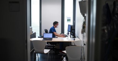 Doctor David Fistera works in his office at the central reception center for corona cases at the University hospital in Essen, western Germany, on March 26, 2020. (AFP Photo)