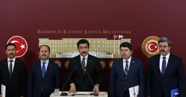 Deputy head of the AK Party's parliamentary group Cahit Özkan (C) reveals the details of the new policy on criminals alongside with deputies from both AK Party and MHP in the parliament, Ankara, Tuesday, March 31, 2020. (AA)