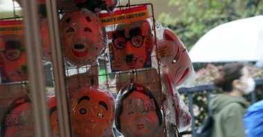 A woman walks near a shop selling face masks in the empty Asakusa district, Tokyo, Japan, Wednesday, April 1, 2020. (AP Photo)