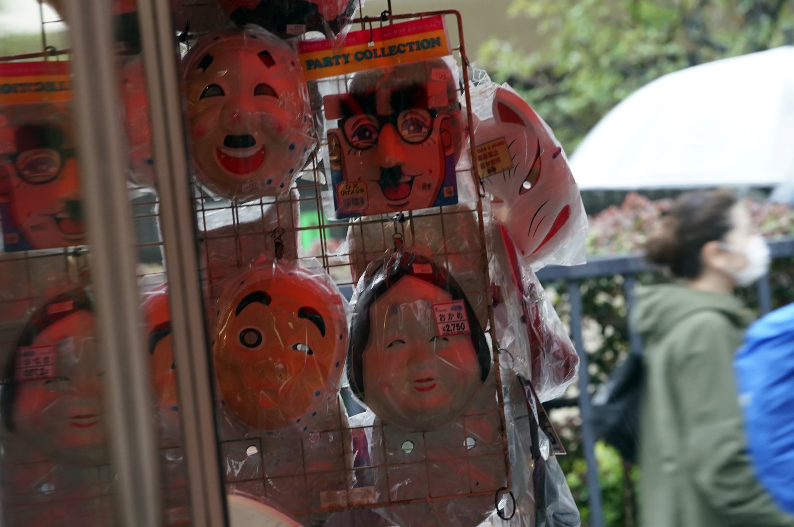 A woman walks near a shop selling face masks in the empty Asakusa district, Tokyo, Japan, Wednesday, April 1, 2020. (AP Photo)
