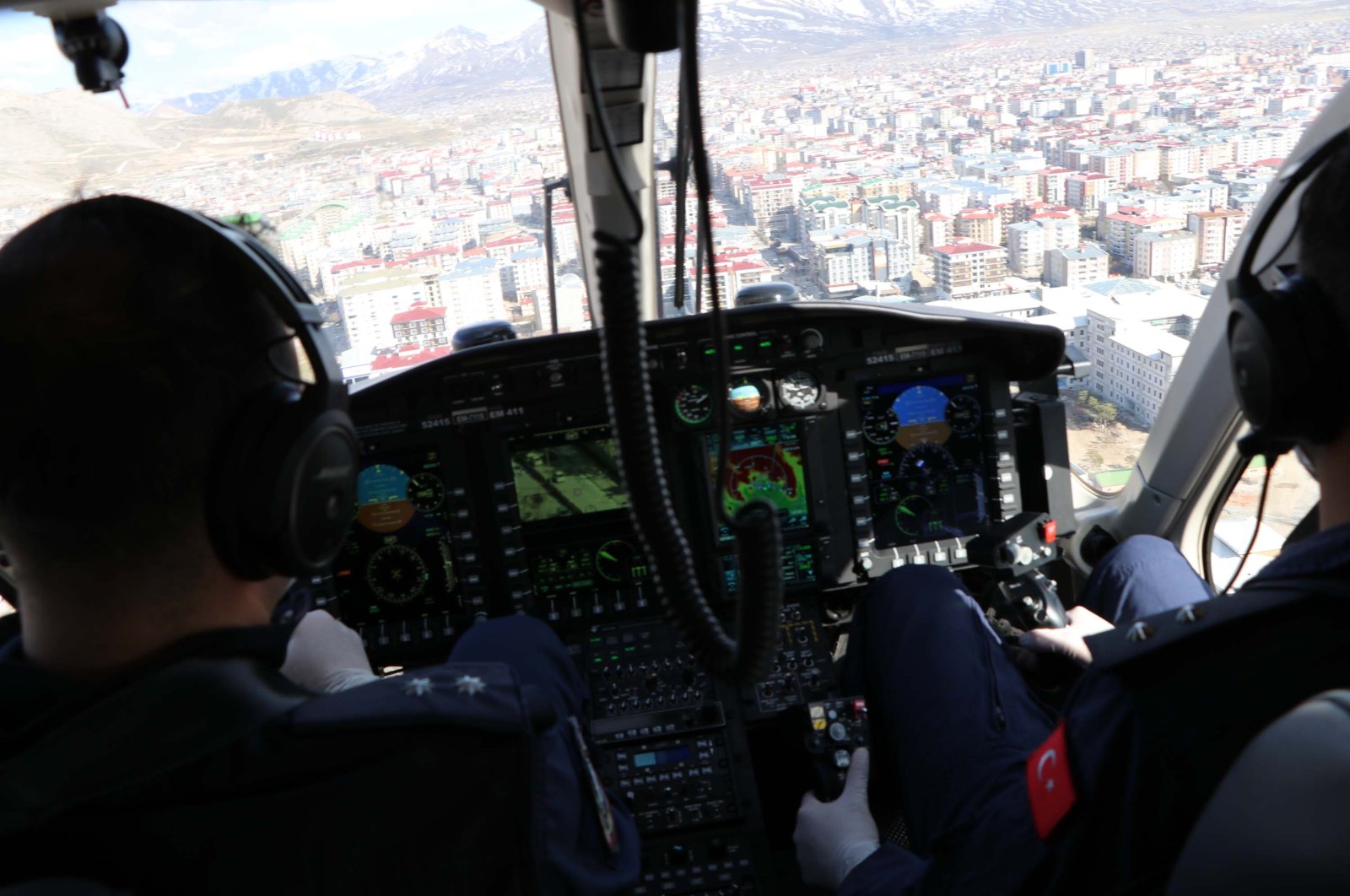 Pilots fly a police helicopter above Van, Turkey, Wednesday, April 1, 2020. (DHA Photo) 
