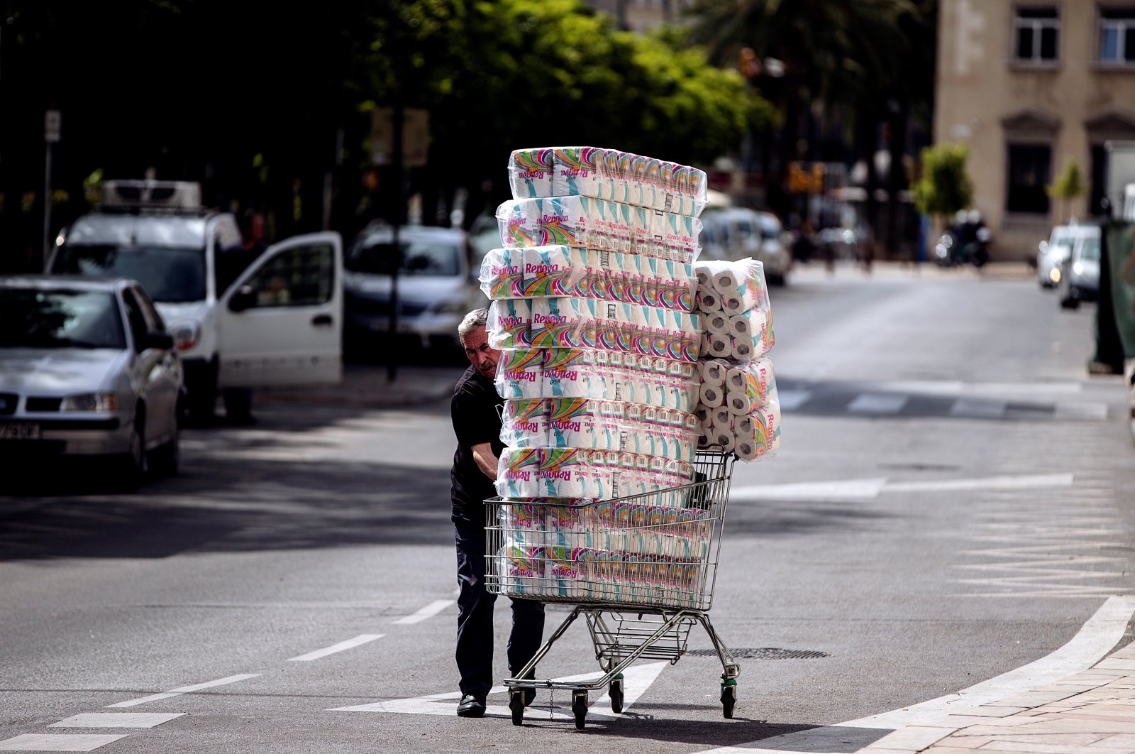 A worker carries many rolls of toilet paper to be sold at a mall in Malaga, Andalusia, Spain, March 12, 2020. (EPA Photo)