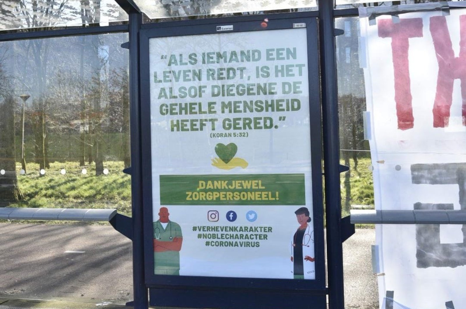 The poster is seen at a bus stop, in Amsterdam, the Netherlands, Tuesday, March 31, 2020. (AA Photo)