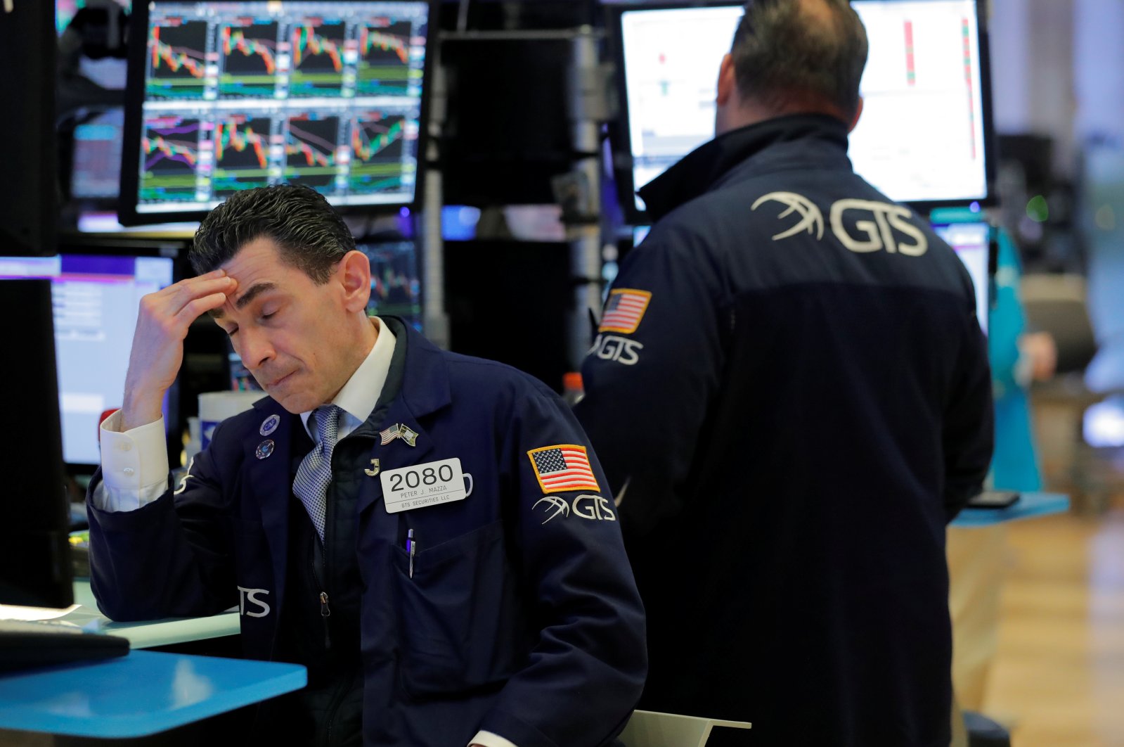 Traders work on the floor of the New York Stock Exchange (NYSE) as the building prepares to close indefinitely due to the COVID-19 outbreak in New York, U.S., Friday, March 20, 2020. (Reuters Photo)