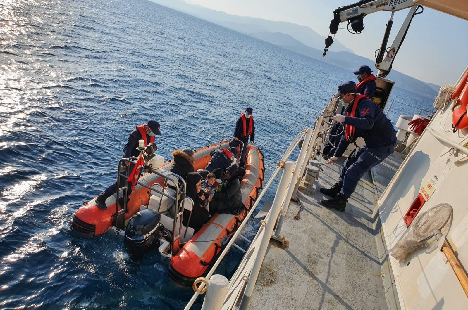 Ten Congolese, eight Syrians, six from the Central African Republic and two Afghans, including children were rescued from a rubber boat off the coast of Kuşadası district in western Aydın province, Thursday, April 2, 2020. (AA)