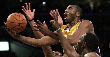 In this Feb. 23, 2007, file photo, Los Angeles Lakers' Kobe Bryant goes up for a shot between Boston Celtics' Paul Pierce and Al Jefferson during the first half of an NBA basketball game in Los Angeles.