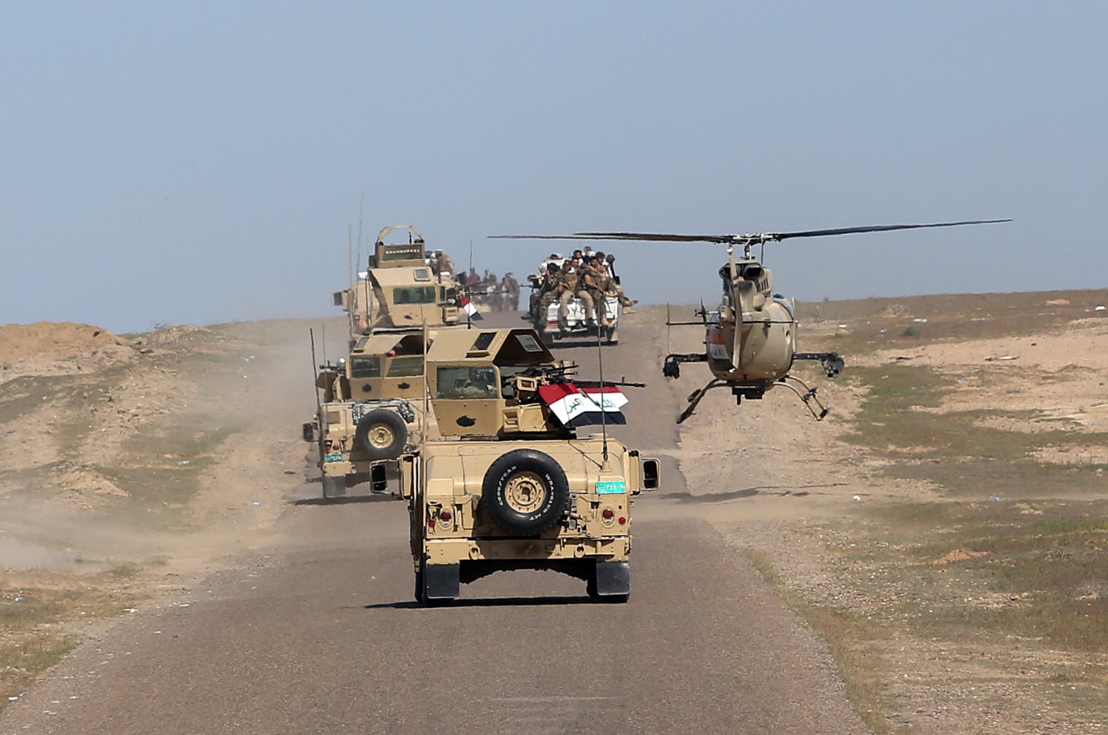 In this photo taken March 9, 2016, Iraqi Defense Minister Khaled al-Obeidi's convoy tours the front line in their fight against Daesh terrorists in the Samarra desert, on the border between Anbar and Salahuddin provinces, Iraq. (AP Photo)