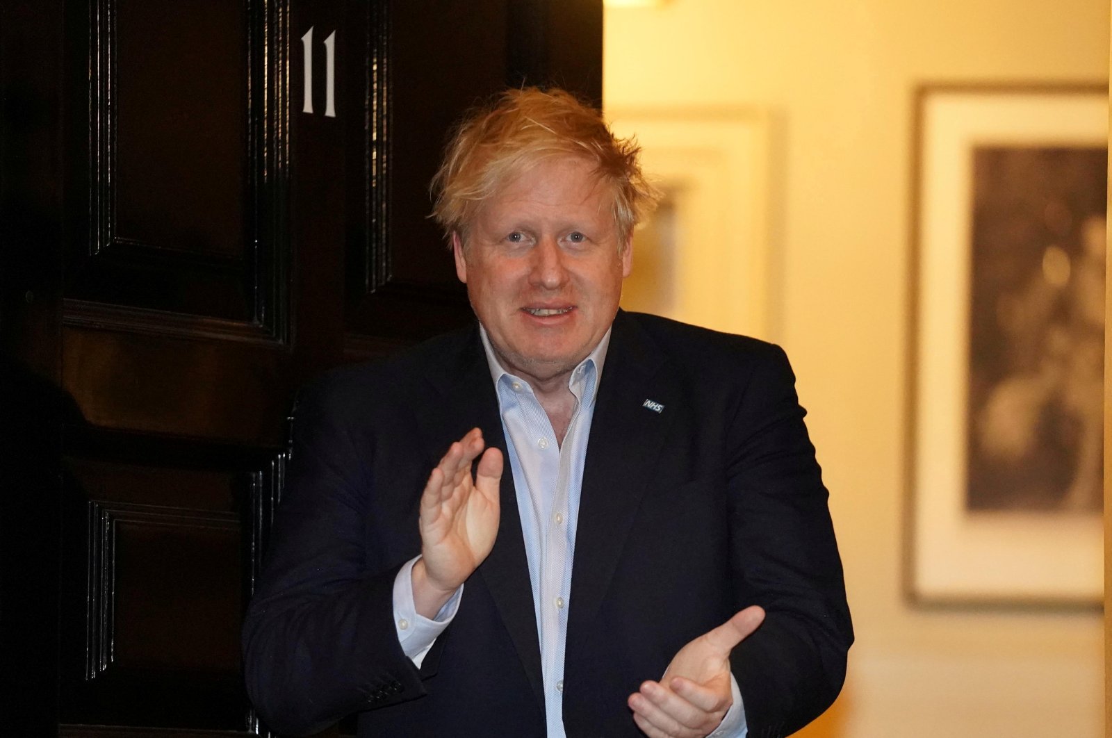 Britain's Prime Minister Boris Johnson applauds in support of the NHS during Clap for our Carers, outside 11 Downing Street in London, Britain, Thursday, April 2, 2020. (Reuters Photo)
