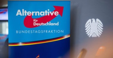 A poster with the AfD logo is pictured next to a Bundestag background banner, Berlin, Sept. 26, 2017. (AFP Photo)