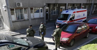 Serbian army soldiers stand guard outside the Clinic for Infectious and Tropical Diseases in Belgrade, Serbia, March 16, 2020. (AP Photo)