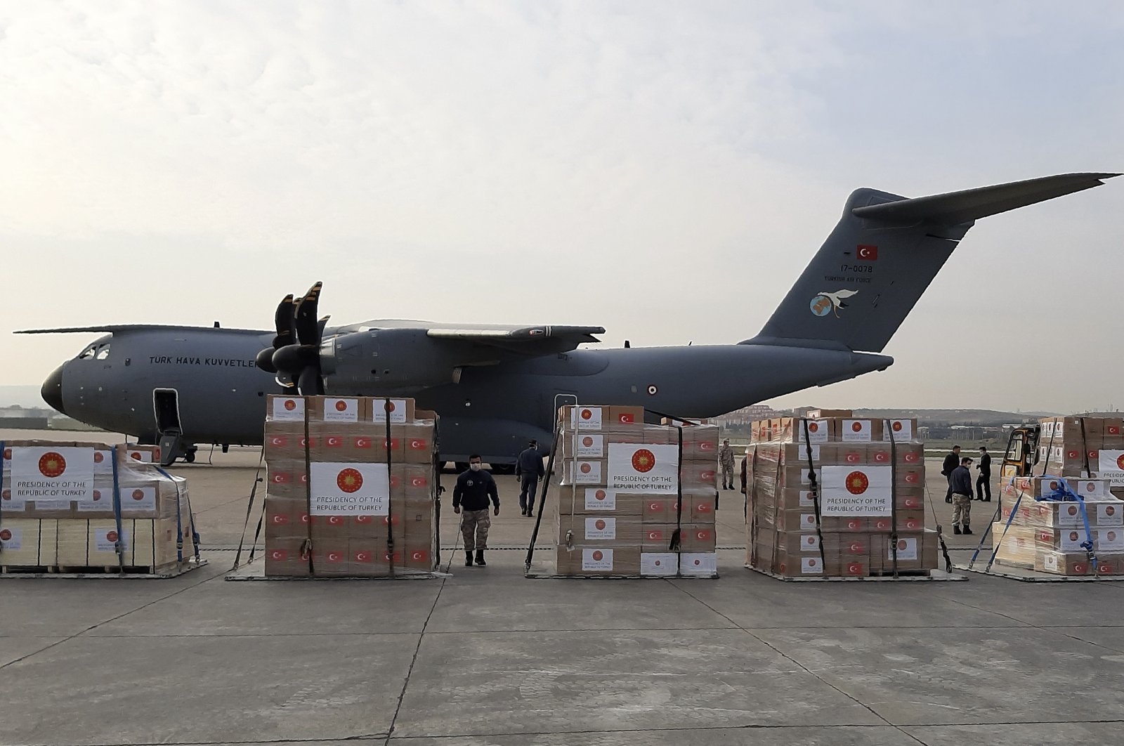 Soldiers prepare to load a military cargo plane with personal protection equipment heading to Italy and Spain to help the countries combat the coronavirus outbreak, Ankara, Wednesday, April 1, 2020. (AP Photo)