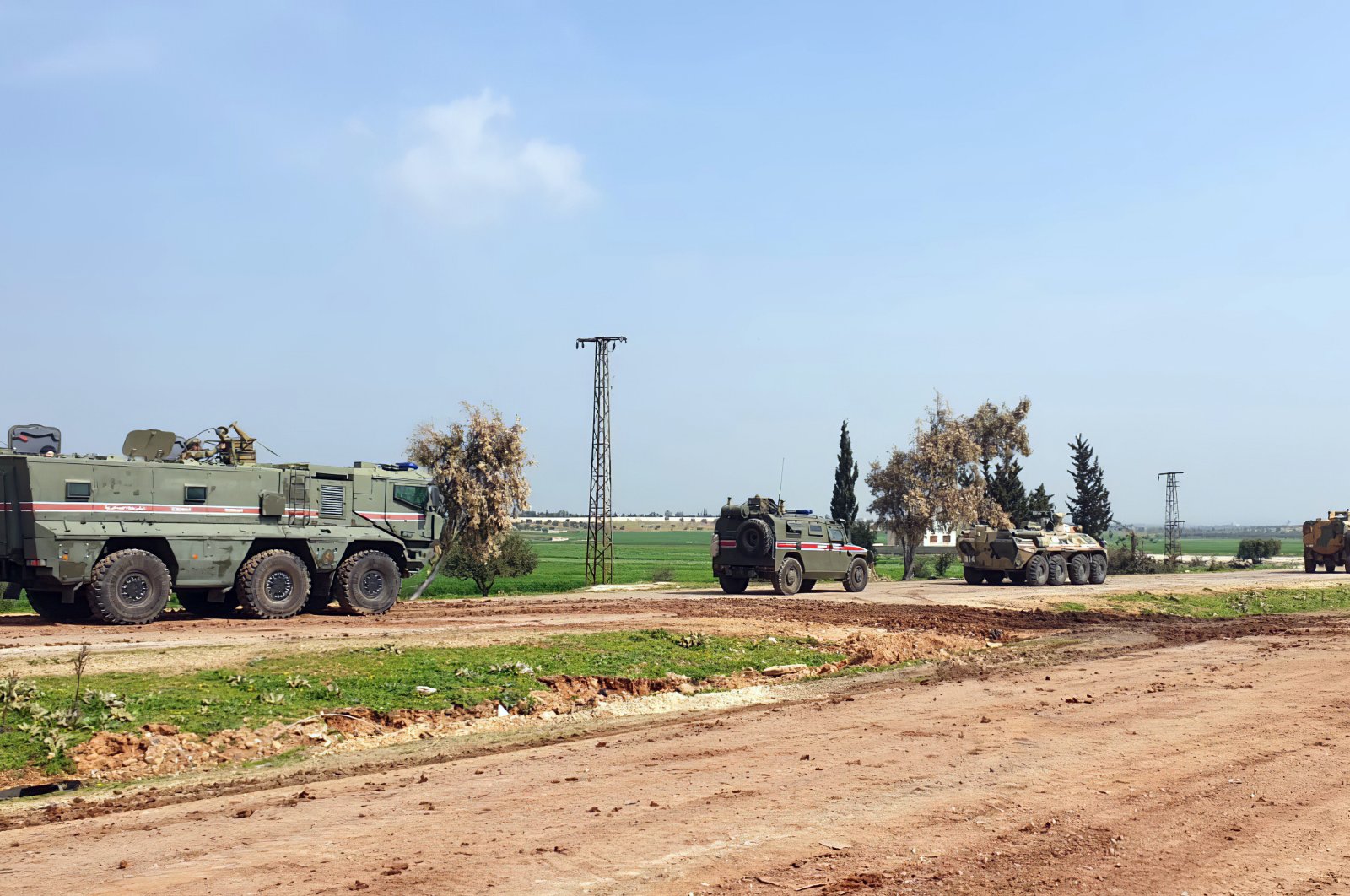 Turkish and Russian troops patrol on the M4 highway, which runs east-west through Idlib province, Syria, Sunday, March 15, 2020. (AP Photo)