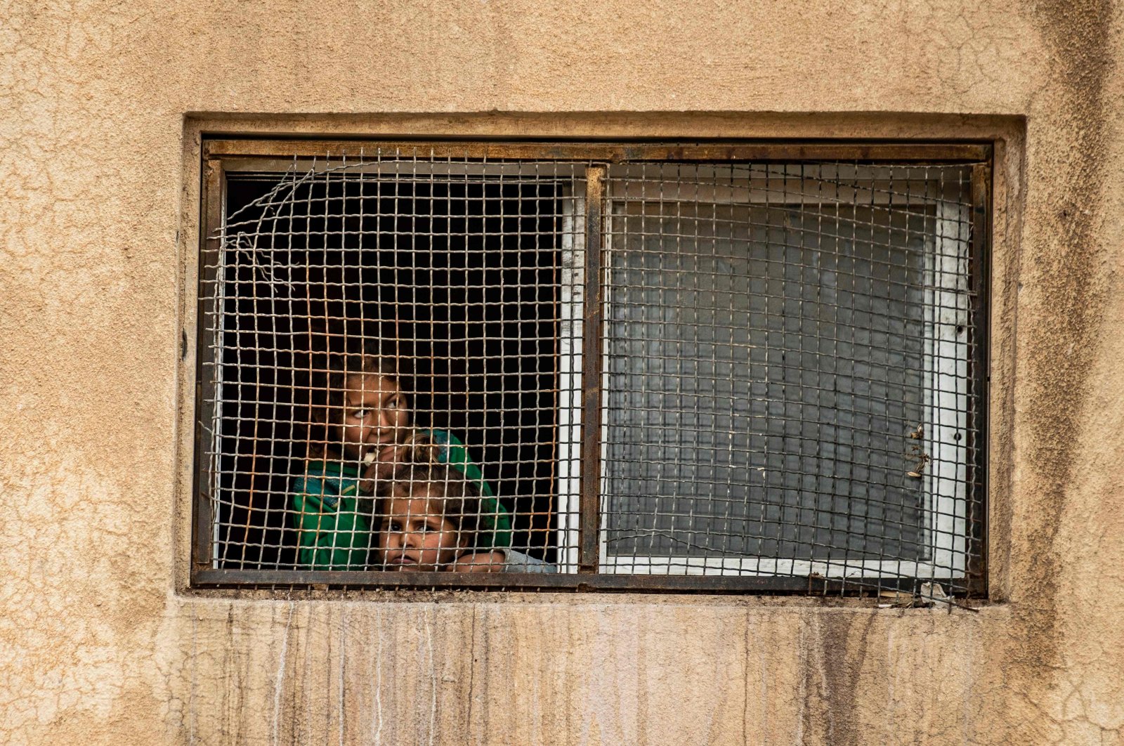 Displaced Syrians stand in a shelter in the northeastern city of  Hasakah, Syria, on Sunday, April 5, 2020 (AFP Photo)