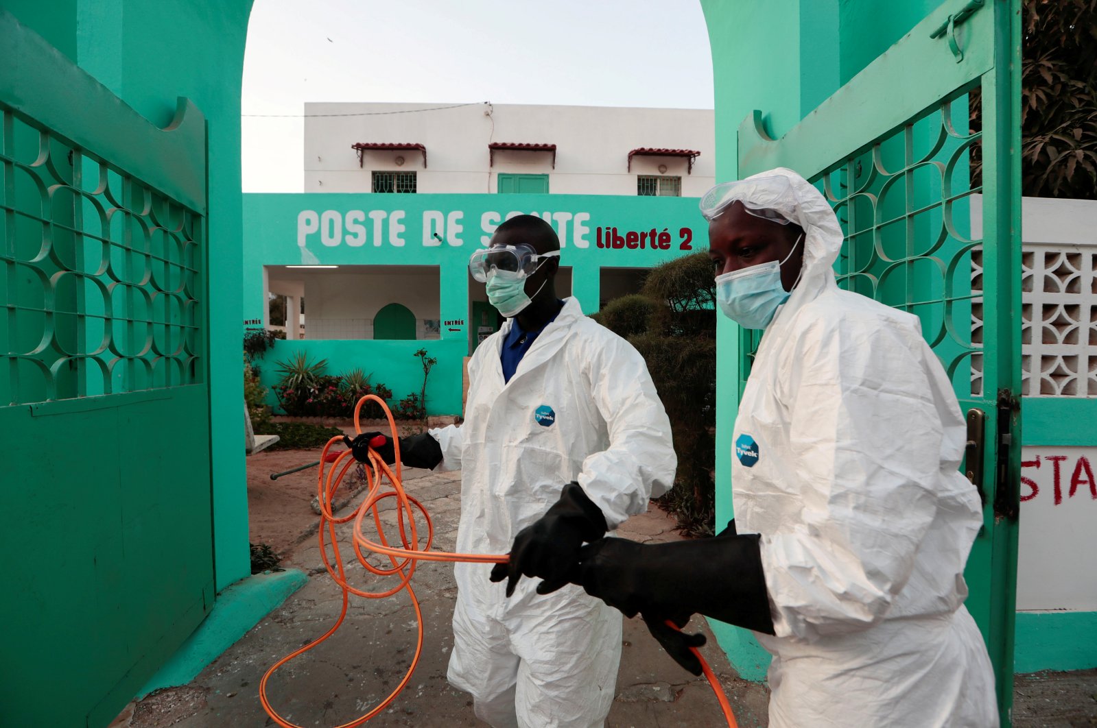 Members of local hygiene services wear protective suits and face masks, as they prepare to disinfect a health center to stop the spread of COVID-19 in Dakar, Senegal, Wednesday, April 1, 2020. (Reuters Photo)